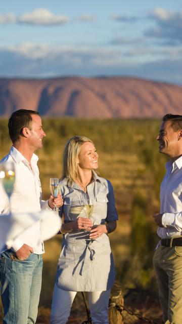 A couple enjoy date night with Uluru in the background